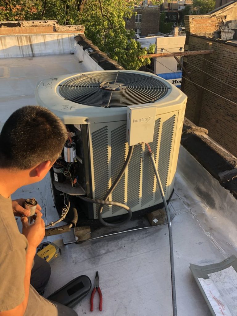 Repairs Air Conditioner on Chicago Roof Building