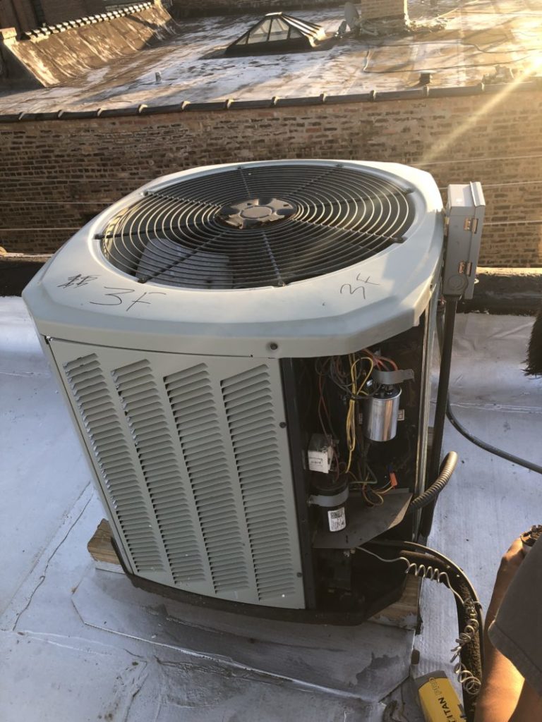 Repairs Air Conditioner on Chicago Roof Building